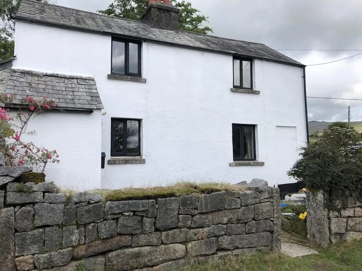 Render repair and exterior repaint of a cottage in Dartmouth